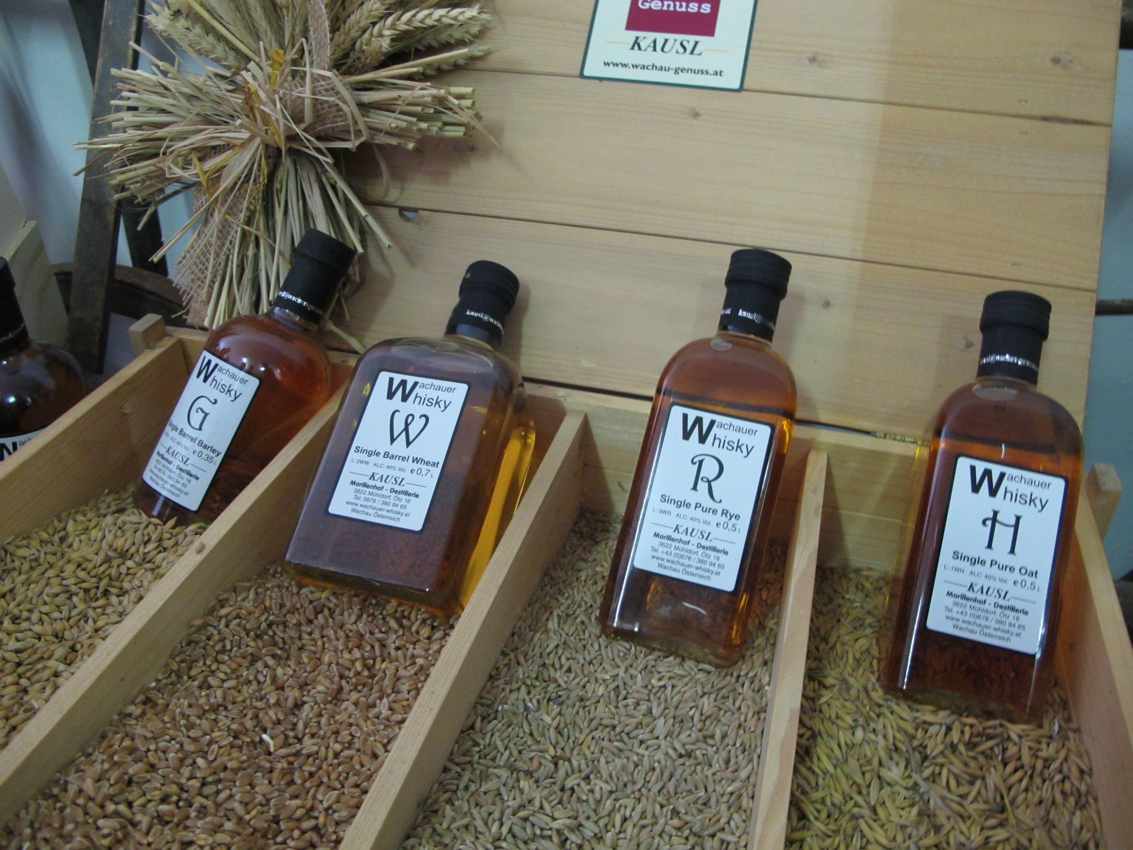 Fľaše whisky Wachau vystavené na obilných zrnách.