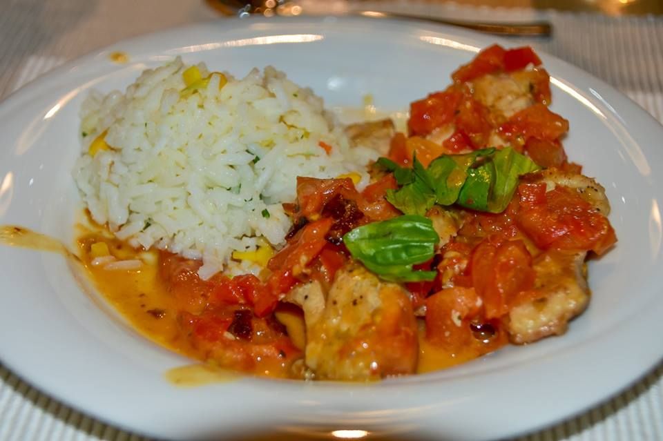 Na tanieri filet z kapra s paradajkovým a bazalkovým ragú a ryžou basmati.