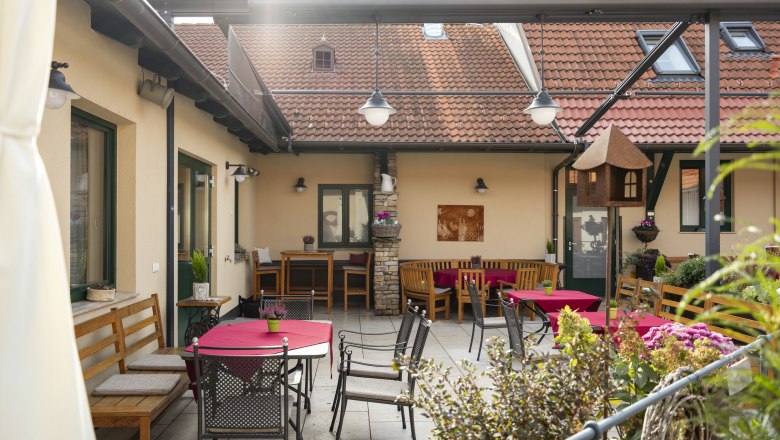 &Uacute;tuln&yacute; vn&uacute;torn&yacute; dvor s poseden&iacute;m a červen&yacute;mi obrusmi.