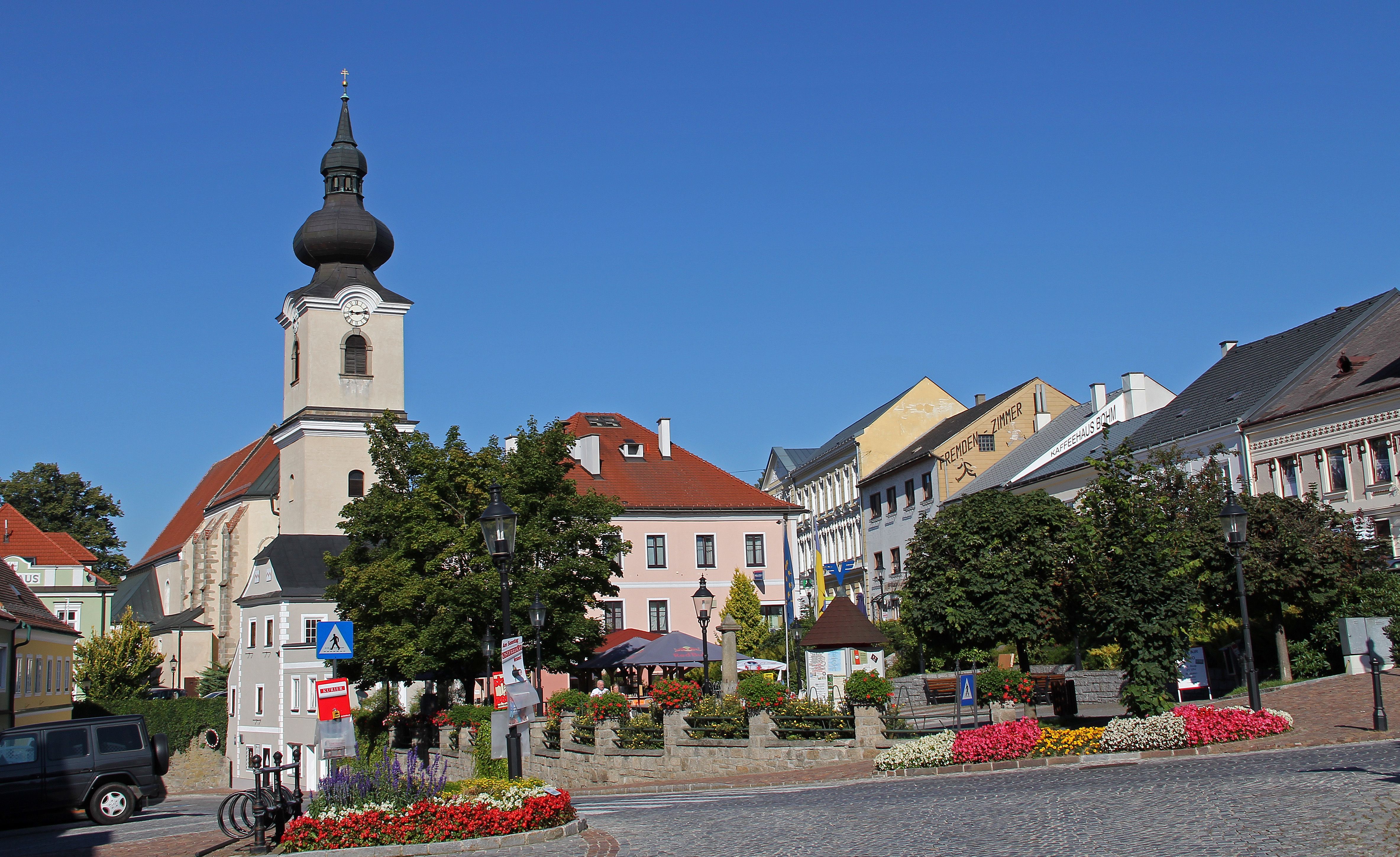 Námestie v Heidenreichsteine s kostolom a farebnými kvetinovými záhonmi.