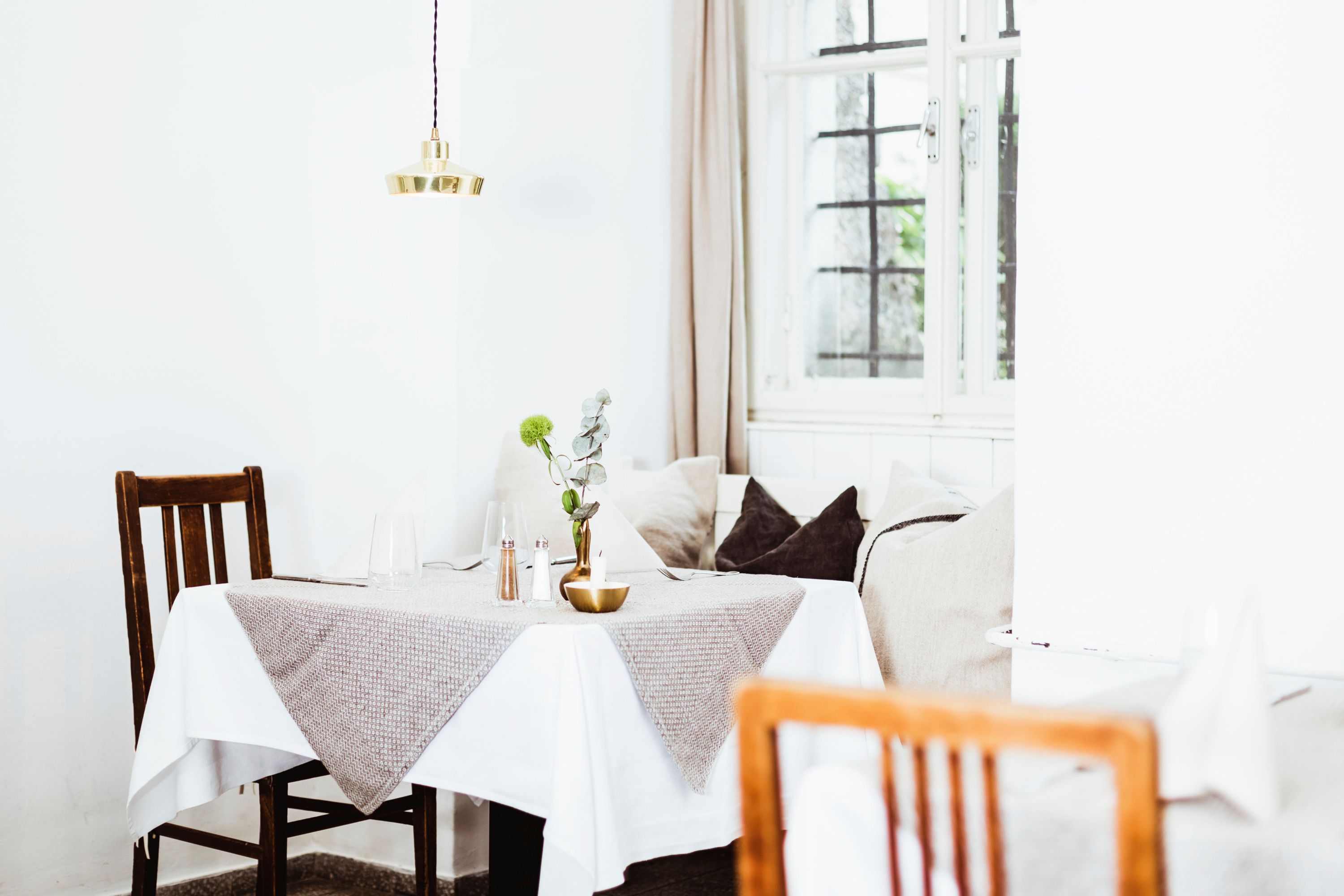 Útulná reštaurácia s dreveným nábytkom a dekoráciami na stole.