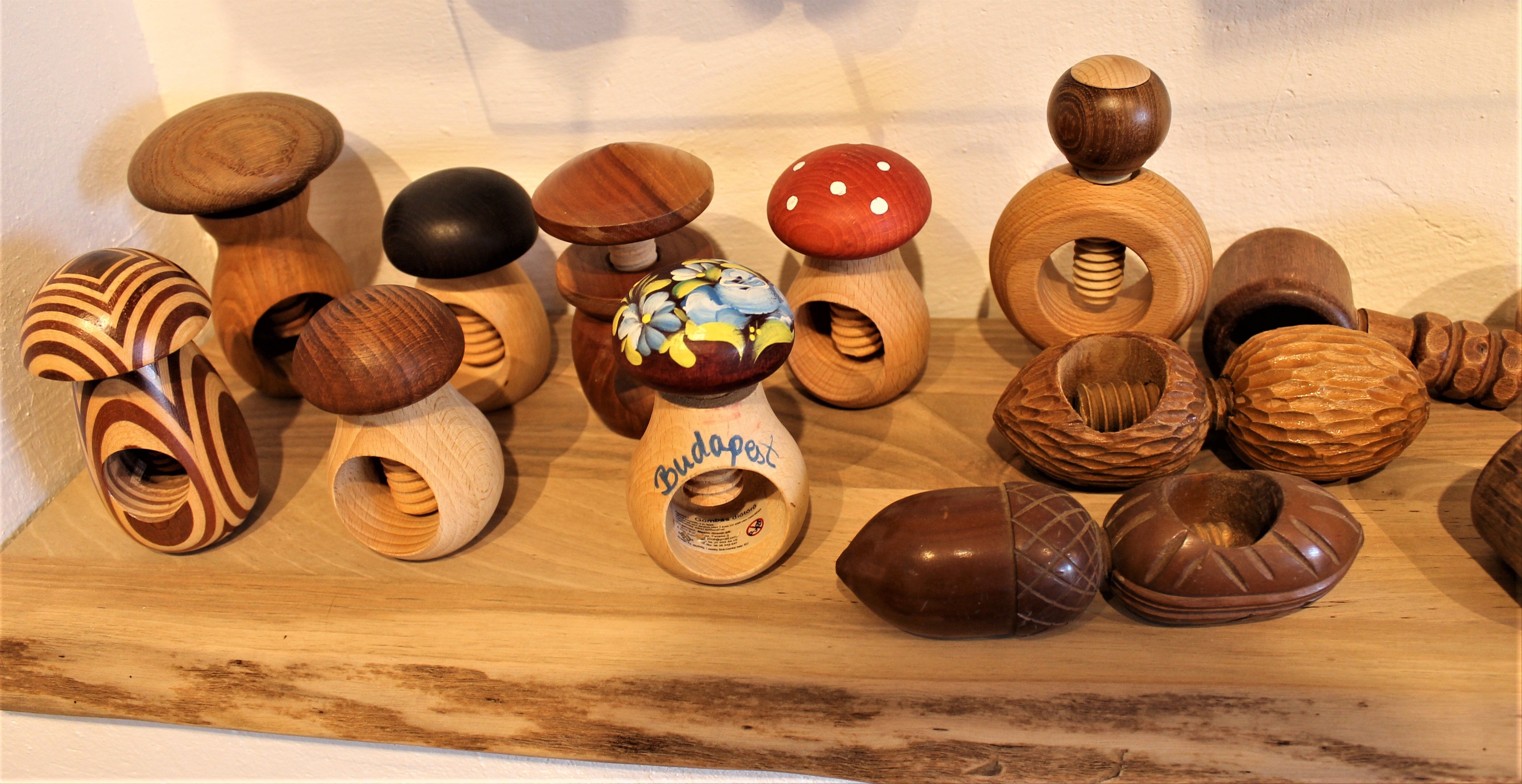 Rôzne drevené luskáčiky v tvare hríbov na polici v Nusseum Krummnußbaum.