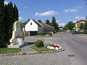 Ulica v Mitterndorfe an der Fischa s domami a pamätníkom.