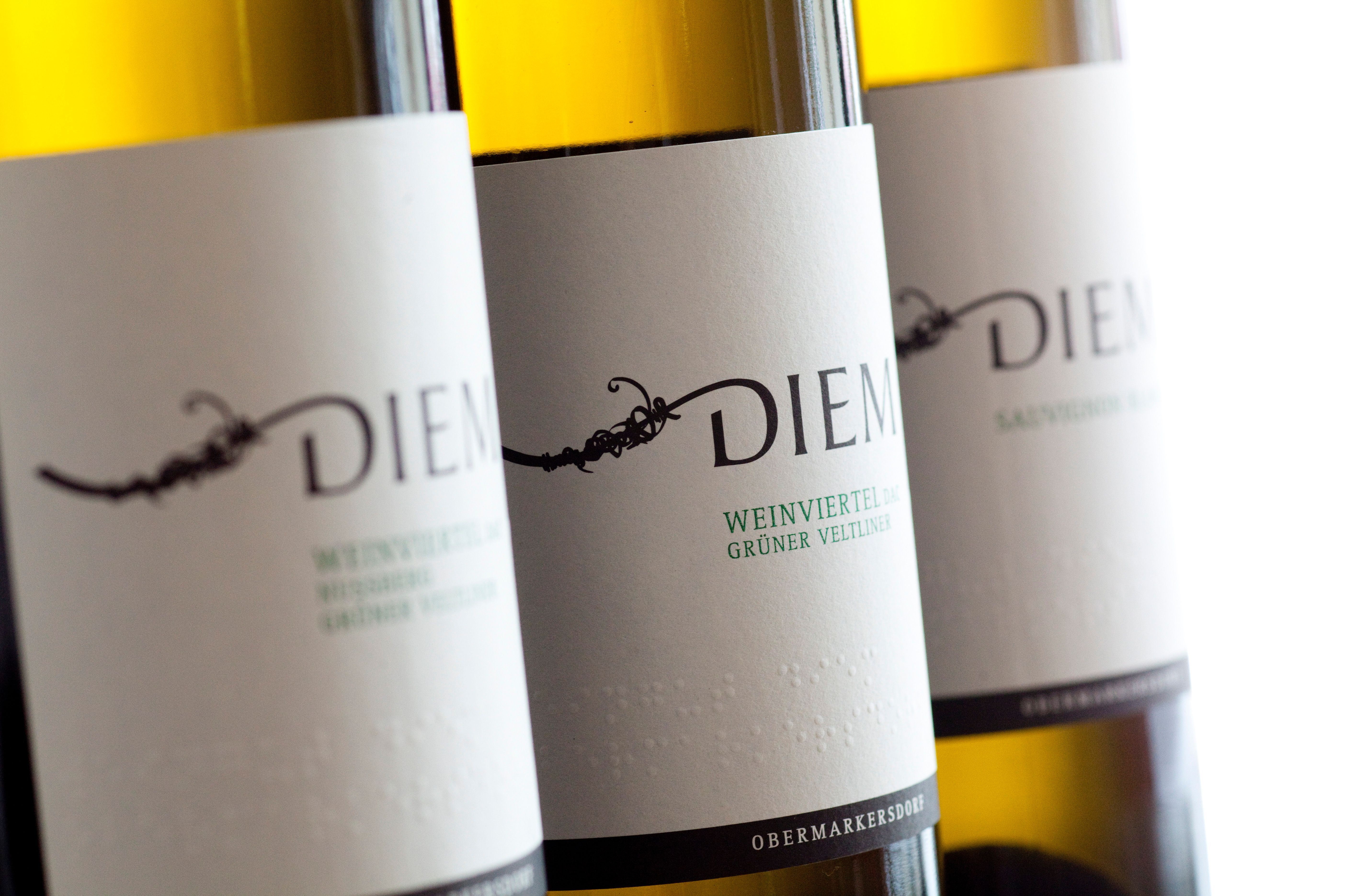 Detailný záber na fľaše s vínom Diem s etiketami pre veltlínske zelené a Sauvignon Blanc.