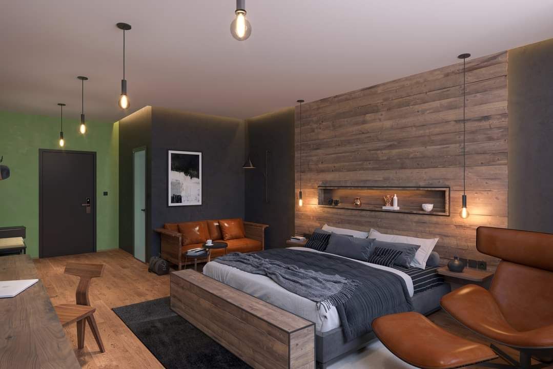 Moderná spálňa s drevenou stenou, veľkou posteľou, koženou pohovkou a štýlovými lampami.