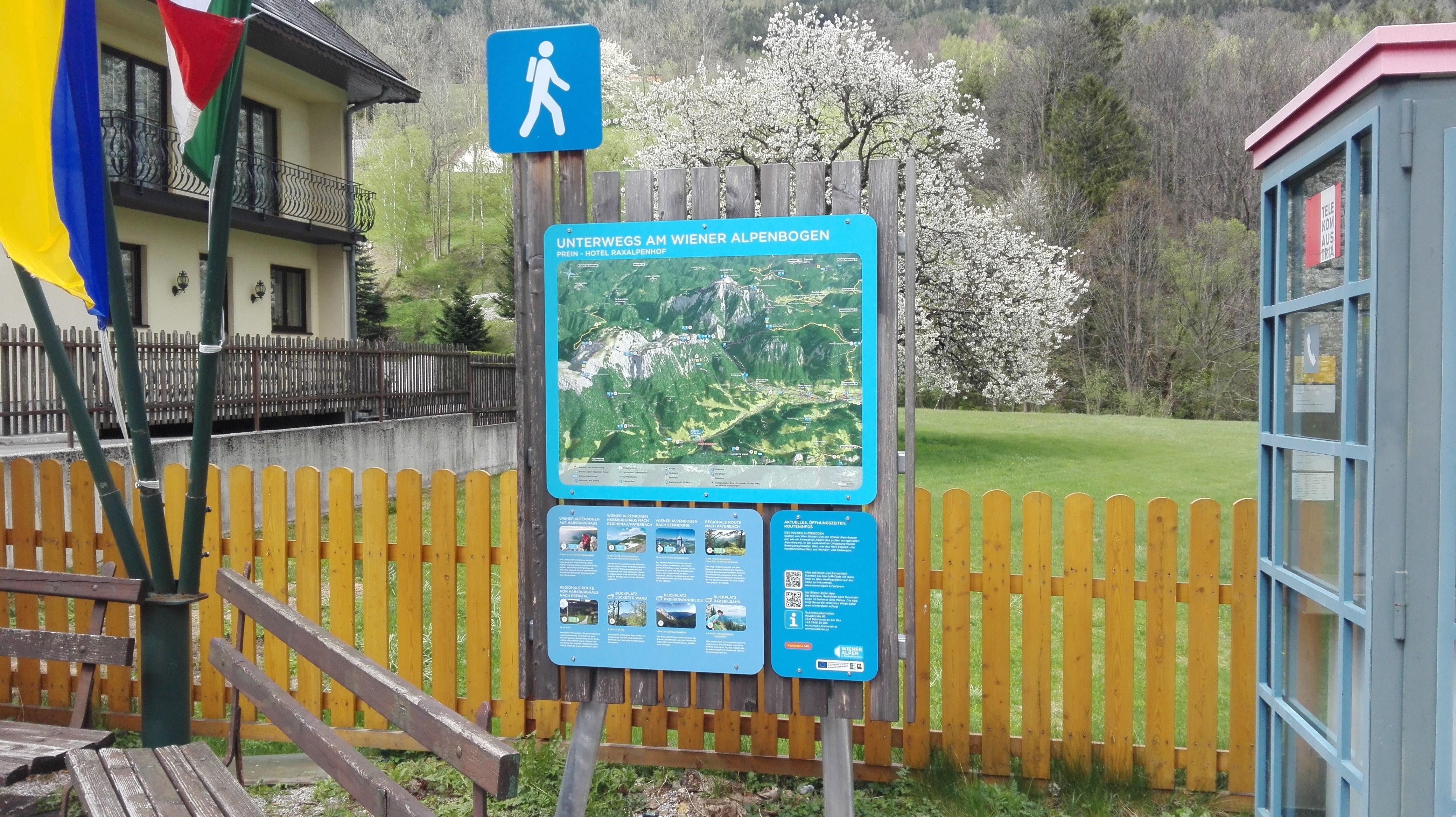 Východiskový bod turistiky Prein s informačnou tabuľou a telefónnou búdkou.