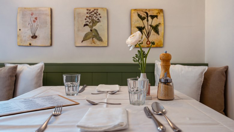 St&ocirc;l prestret&yacute; v re&scaron;taur&aacute;cii s kvetmi a koren&iacute;m.