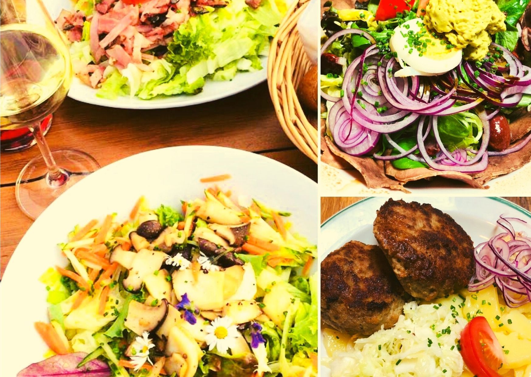 Rôzne taniere so šalátmi, mäsom a pohárom bieleho vína.