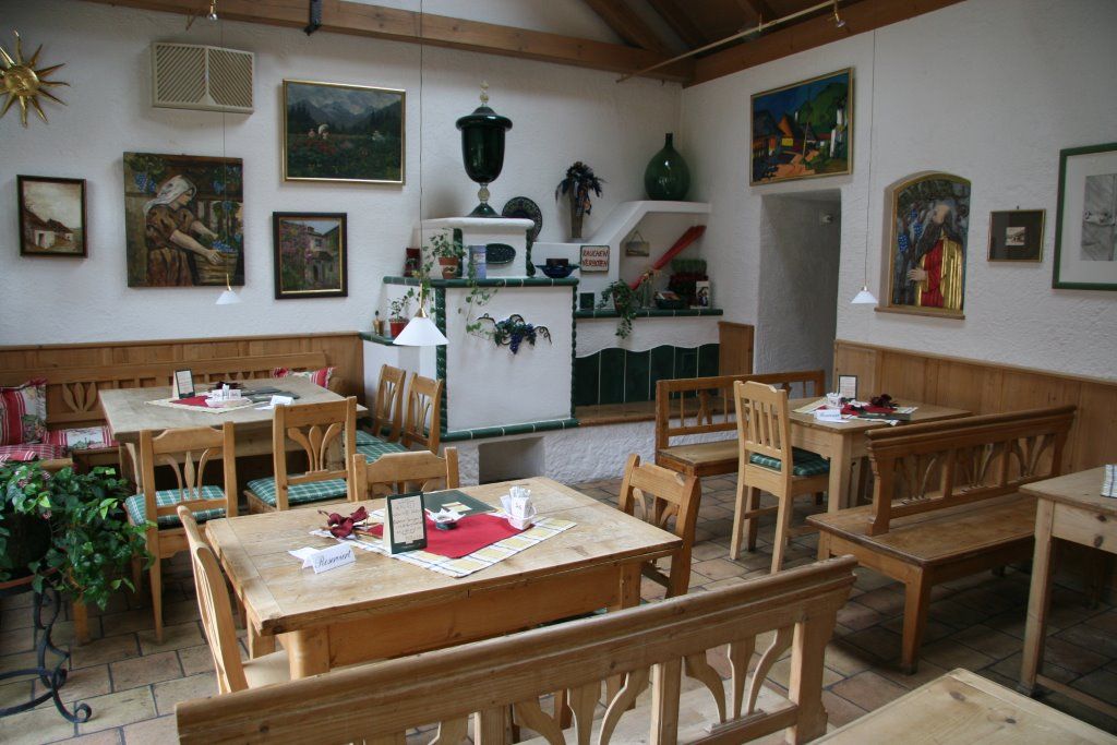 Útulná jedáleň s dreveným nábytkom a dekoratívnymi maľbami na stenách.