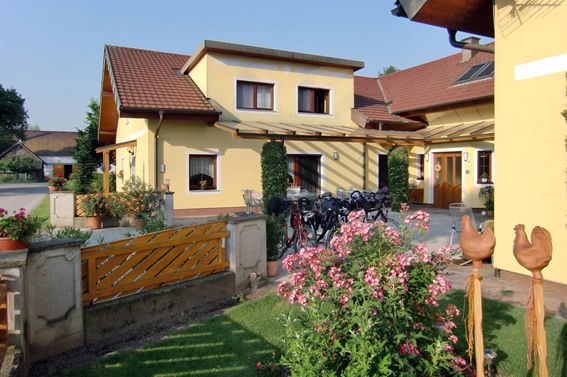 Žltý dom so záhradou a bicyklami pred dverami.