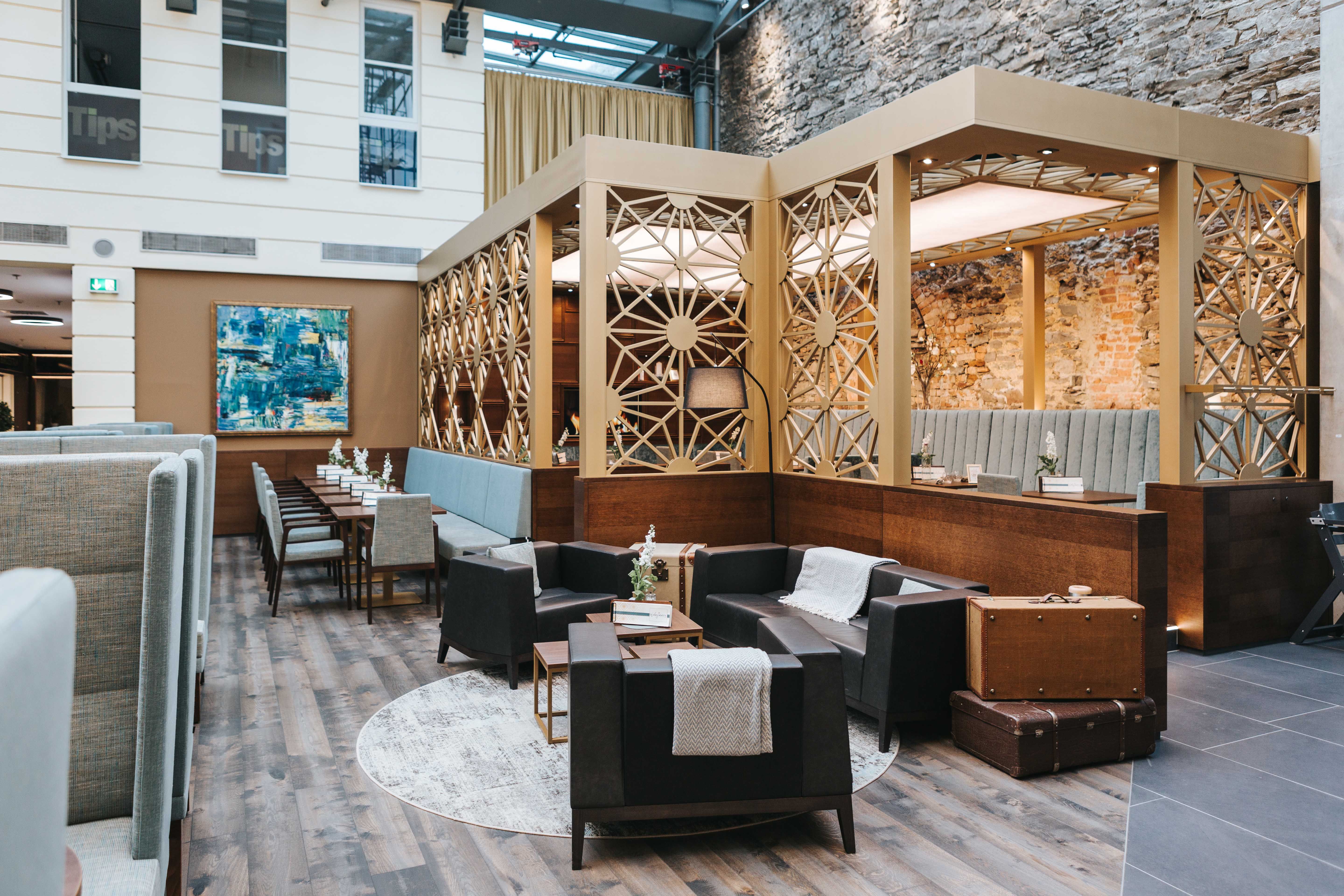 Pohľad do interiéru štýlovej kaviarne s moderným nábytkom a dekoratívnymi stenami.