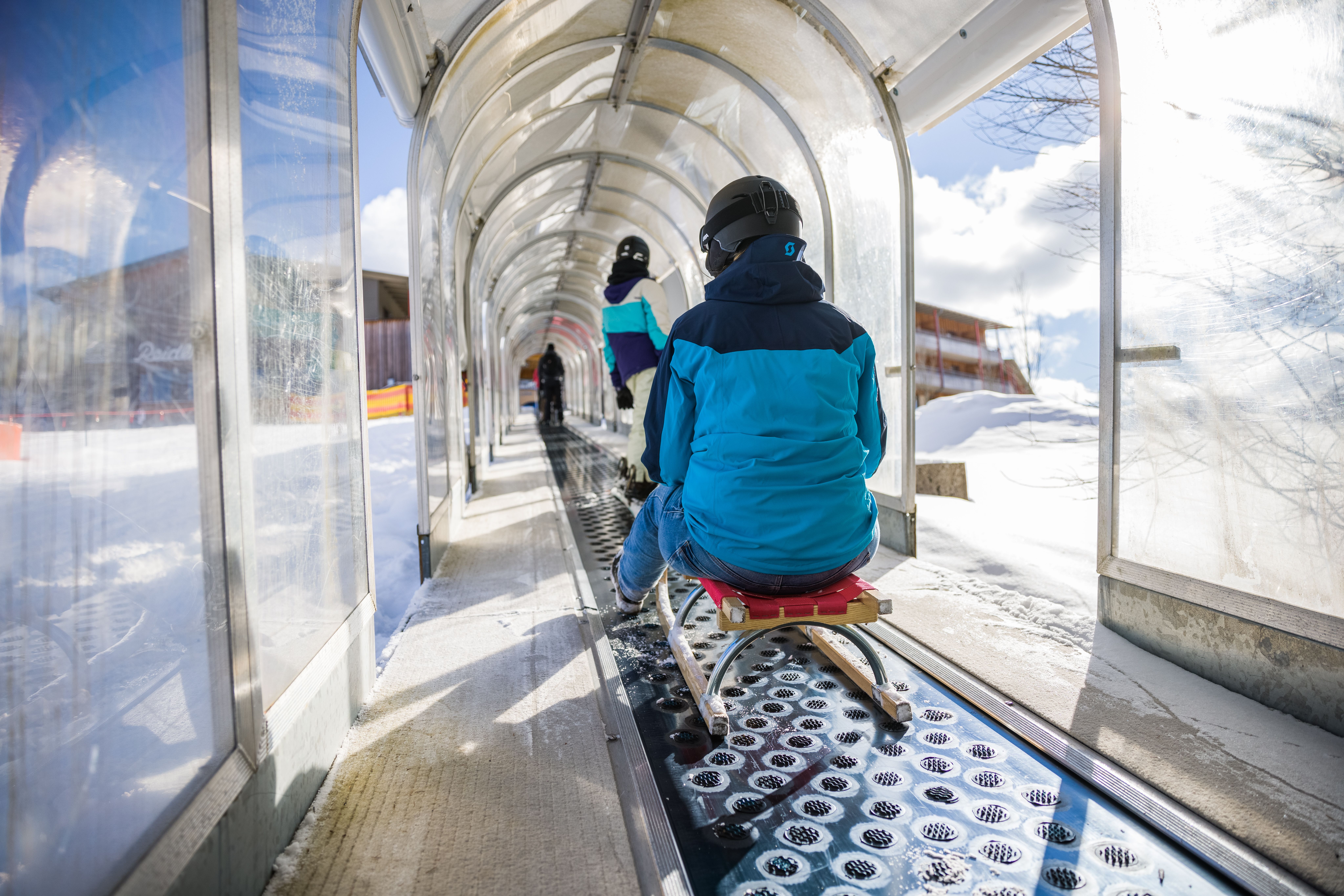 Ein aufregendes Abenteuer erwartet die Besucher, während sie auf dem Förderband sanft den Hang hinauf gleiten. Umgeben von schneebedeckten Bergen und glitzerndem Schnee, ist der Spaß beim Rodeln garantiert. Hier in Annaberg wird der Winter zum unvergesslichen Erlebnis für die ganze Familie.